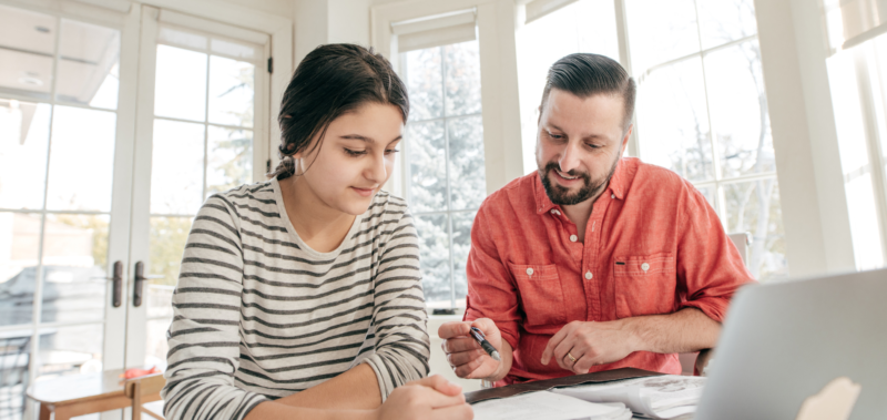Father with his teenage daughter going through resutls
