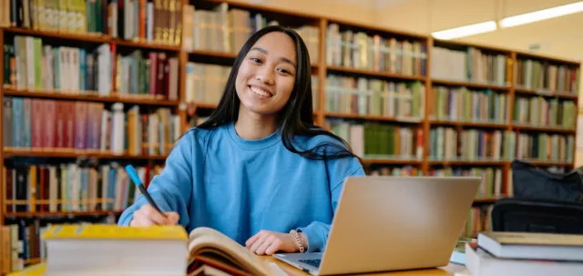 Student in a library with her books