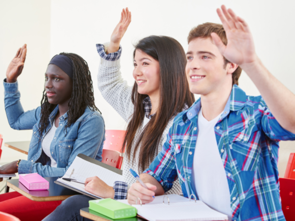 Students with their hands raised